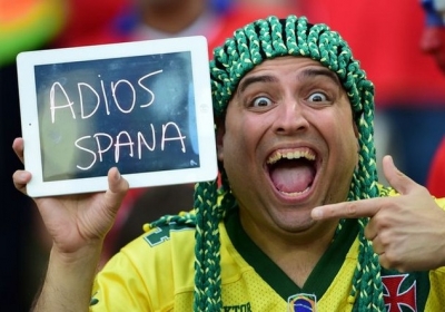 Бразилия, Рио-де-Жанейро, 18 июня 2014. Чилийский болельщик держит планшет с надписью "Прощай, Испания" после того, как сборная Испании проиграла команде Чили со счетом 0:2 и не прошла в 1/8 финала чемпионата мира. Фото: АFР
